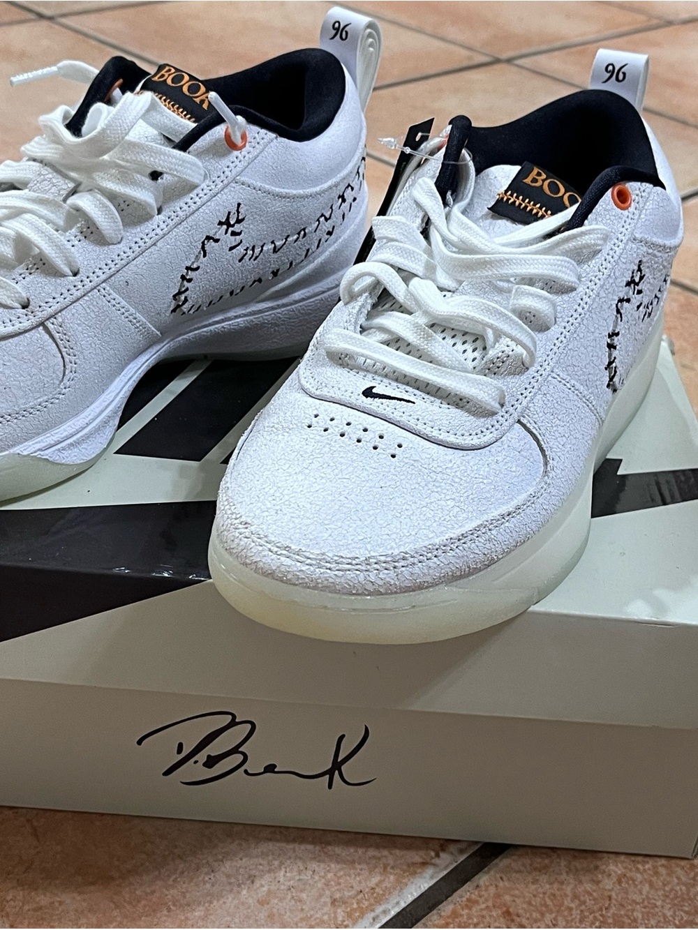 Nike White Low-Top Sneakers with Black and Orange Accents